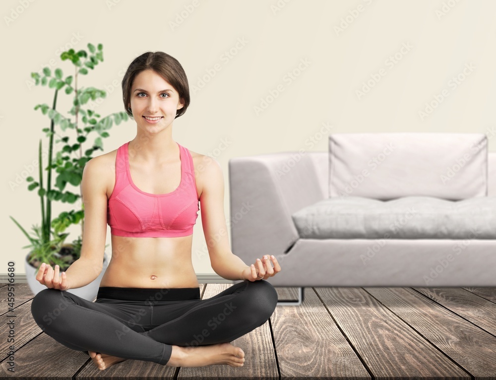 The girl does yoga, woman at home practices asanas. Hands on chest, mudra. The girl does yoga, woman at home practices asanas. Hands on chest, mudra.