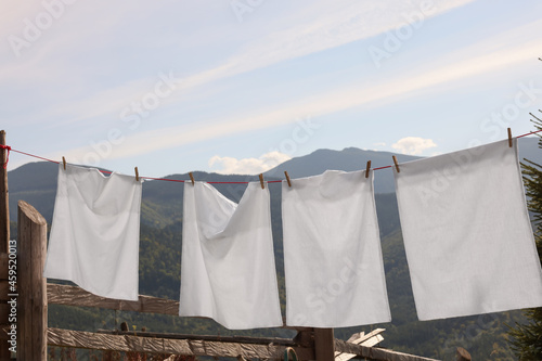 Laundry with clothes pins on line outdoors © New Africa