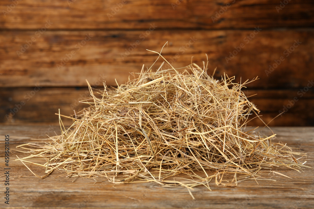 Heap of dried hay on wooden table