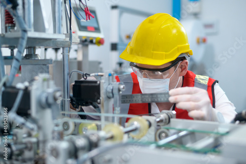 Slika na platnu Quality control (QC) engineer monitoring and checking machine system in manufact