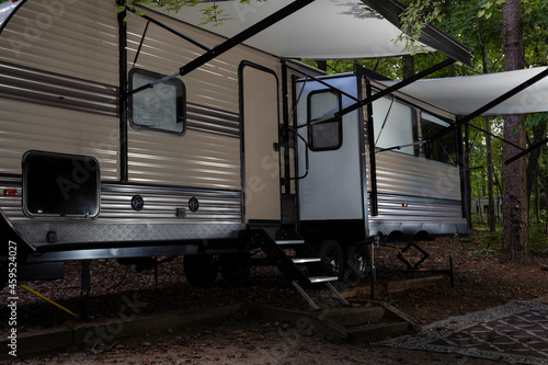 Camping trailer with awnings extended © Guy Sagi