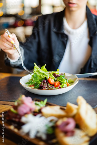 woman eating salad in the restaurant