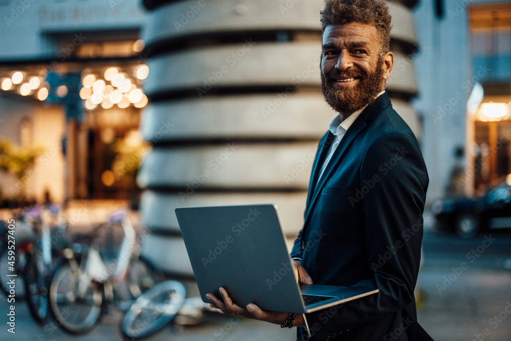 Smiling male professional holding digital tablet on street Smiling male professional holding digital tablet on street