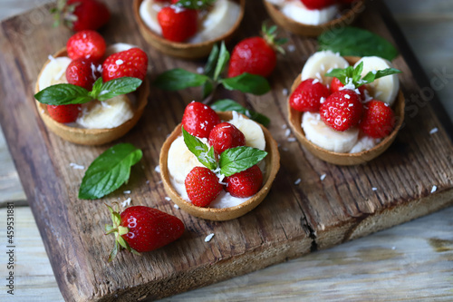 Delicious tartlets with strawberries and banana. Healthy dessert.