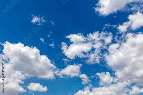 Fototapeta Naklejka Na Ścianę i Meble -  Fluffy cumulus clouds on blue sky background. Cloudscape white and grey color
