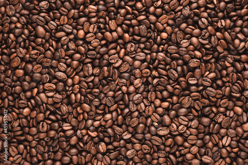 Coffee beans texture or coffee beans background. Brown roasted coffee beans. Closeup shot of coffee beans. Many coffee beans. Coffee beans can be used as a background. Fresh roasted coffee beans.