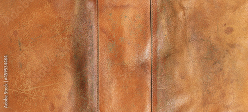 old scratched worn orange leather background and texture