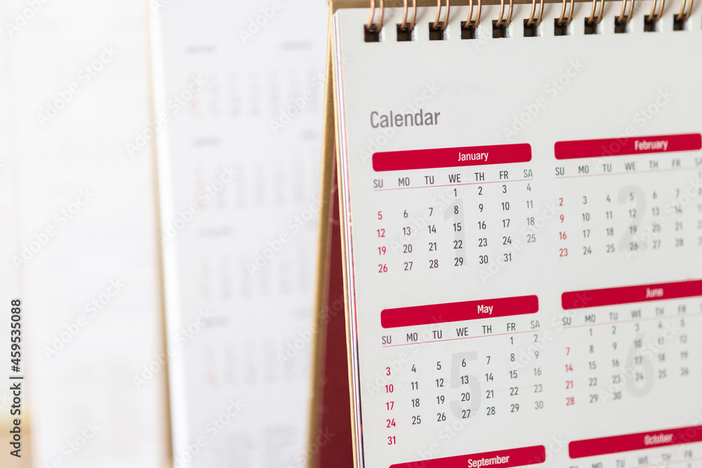 Close up calendar page dates and month background business planning appointment meeting concept Close up calendar page dates and month background business planning appointment meeting concept