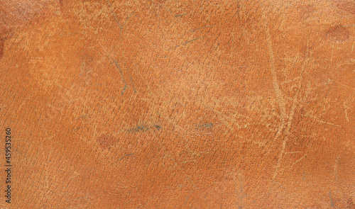 old scratched worn orange leather background and texture