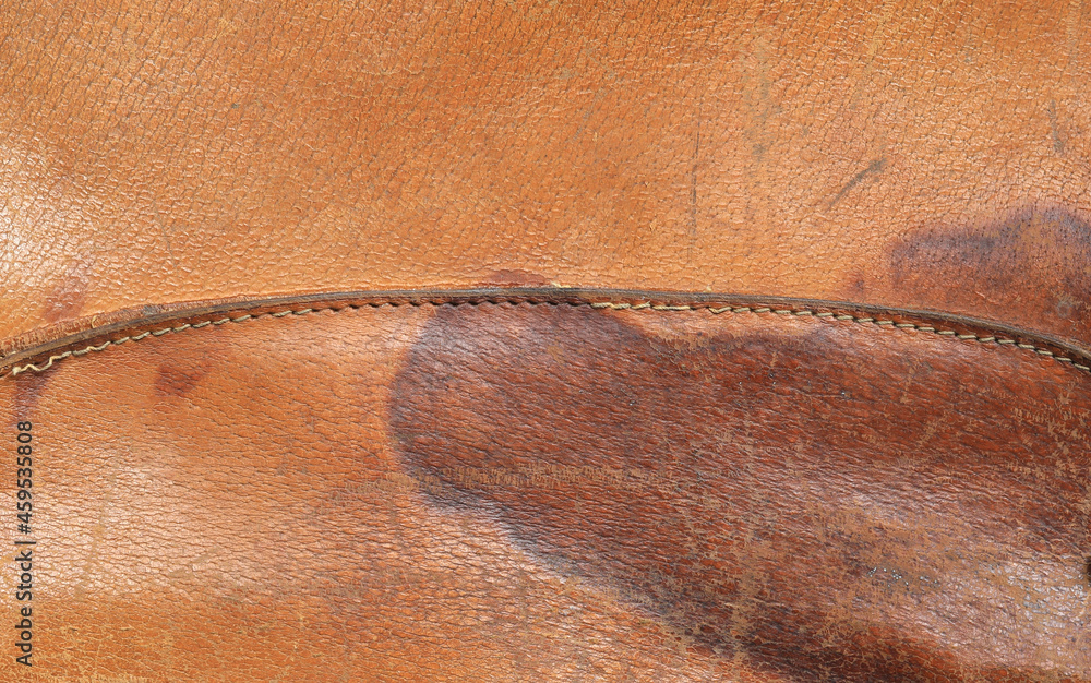 Fototapeta premium old scratched worn orange leather background and texture