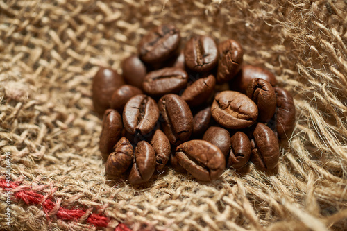 Roasted coffee beans on piece of sackcloth