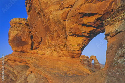 Landscape near sundown of Delicate Arch framed by rock window, Arches National Park, Utah, USA