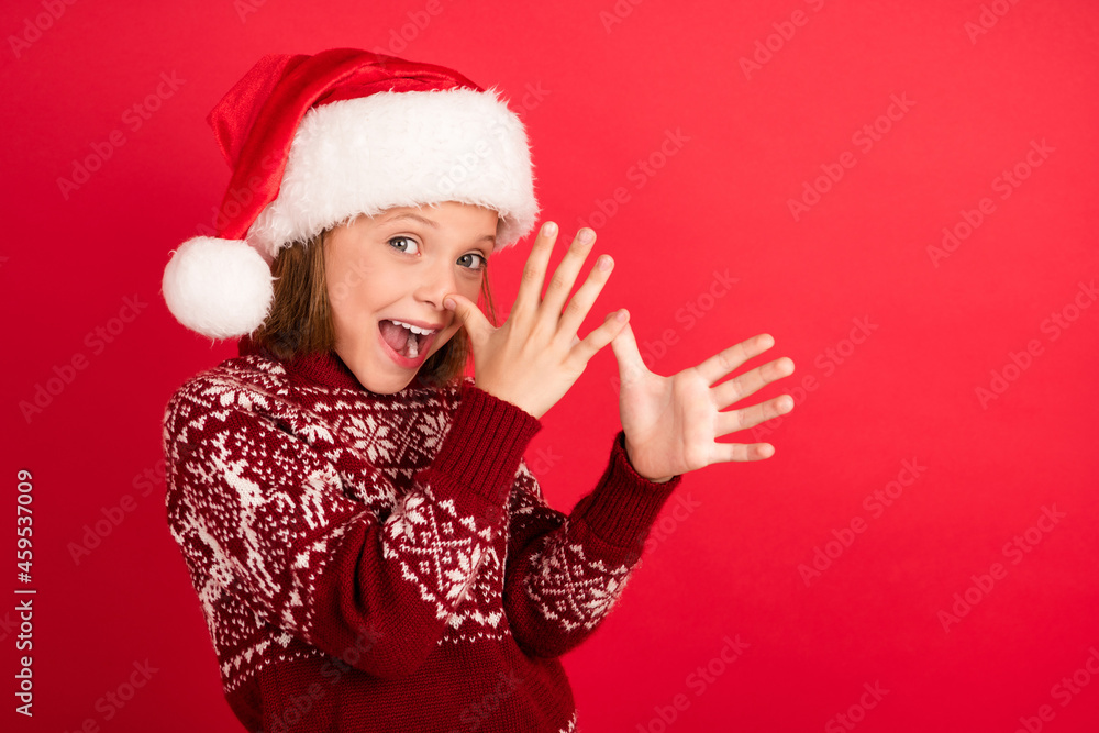 Profile side photo of young girl happy positive smile humor joke hands nose fooling christmas isolated over red color background Profile side photo of young girl happy positive smile humor joke hands nose fooling christmas isolated over red color background