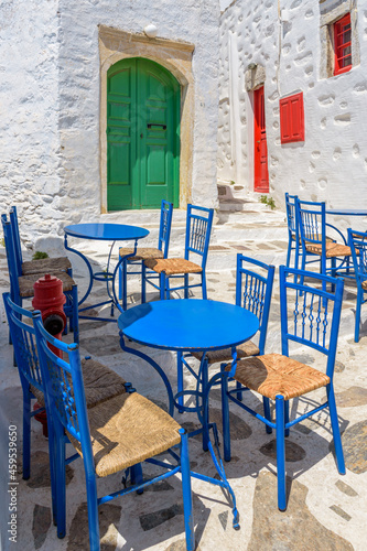 Traditional cycladitic   alley with a  whitewashed  facades and an exterior of a cafe  in chora Amorgos  Greece © valantis minogiannis
