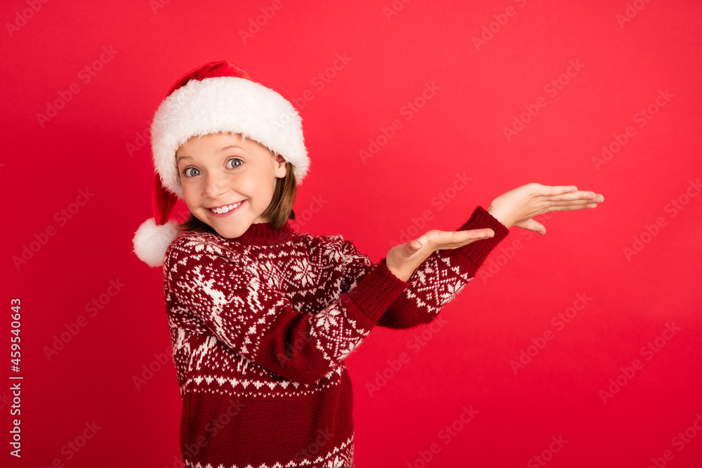 Portrait of attractive cheerful girl having fun eve holding on palms copy space isolated over bright red color background Portrait of attractive cheerful girl having fun eve holding on palms copy space isolated over bright red color background