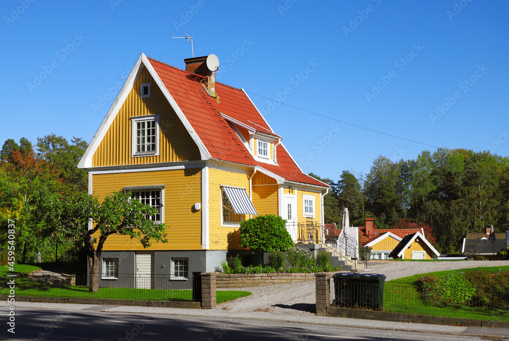 Yellow house single-family house with tiled gabled roof on two floors with basement built in the 1920s. - obrazy, fototapety, plakaty 