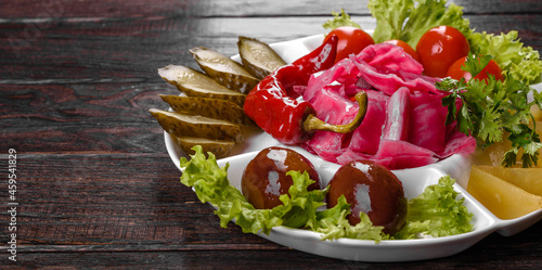 Delicious spicy pickles cut on a serving plate