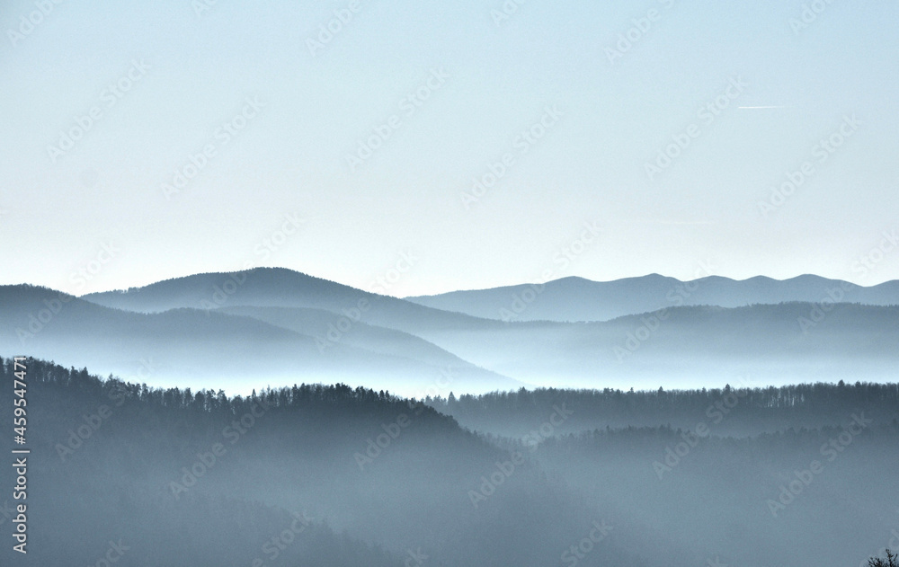 panorama of mountain peaks in the fog