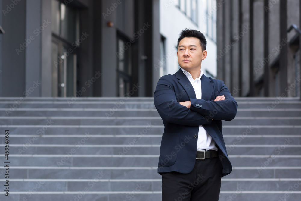 Portrait of asian serious businessman near office in business suit confident broker sales manager Portrait of asian serious businessman near office in business suit confident broker sales manager