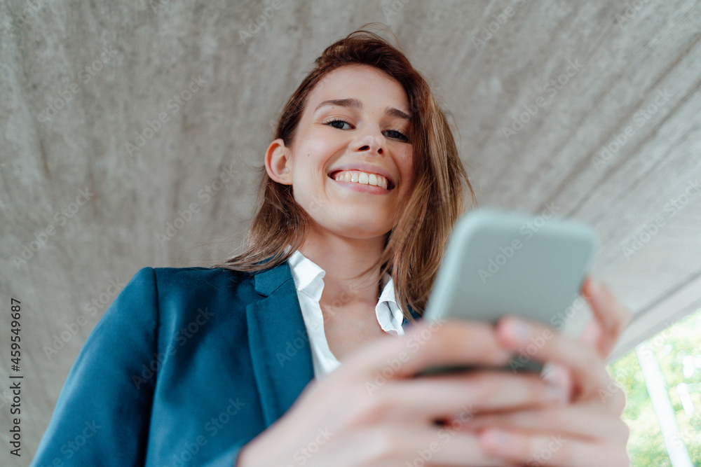 Female professional with mobile phone in basement Female professional with mobile phone in basement