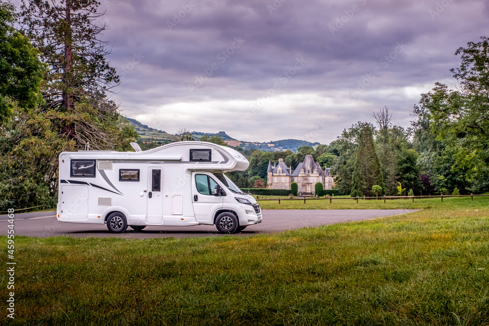 Motorhome parked in front of a small chateau (castle) in the Normandy department, France