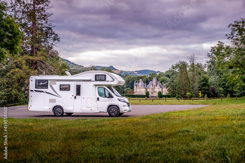 Motorhome parked in front of a small chateau (castle) in the Normandy department, France