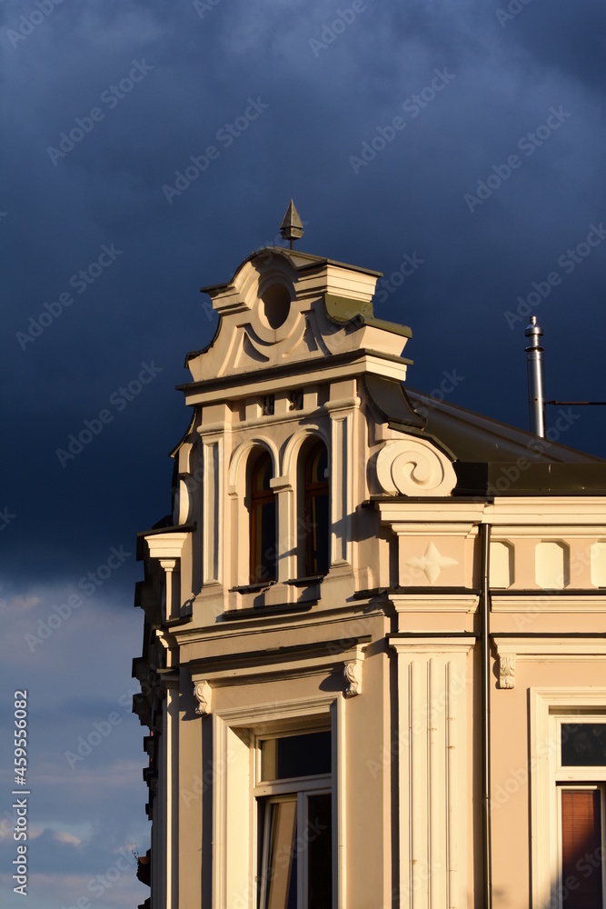 The front of the historic building against the backdrop of severe storm clouds. Architecture. House.