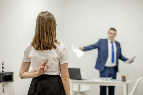 Fototapeta Naklejka Na Ścianę i Meble -  Angry boss yelling at his young employee, she is stressed and feeling frustrated: hostile boss and mobbing concept
