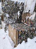 briquettes of compressed garbage after the sorting process of household garbage in winter at the landfill, aluminum cans from beer recycling