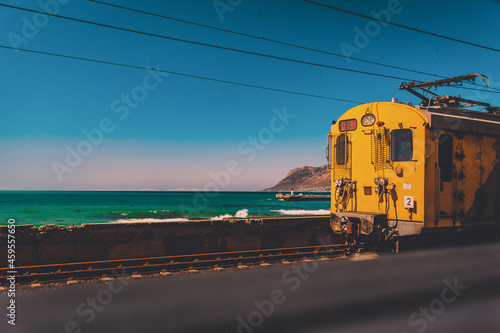 Yellow old train on a railway by the sea oin Cape Town, South Africa