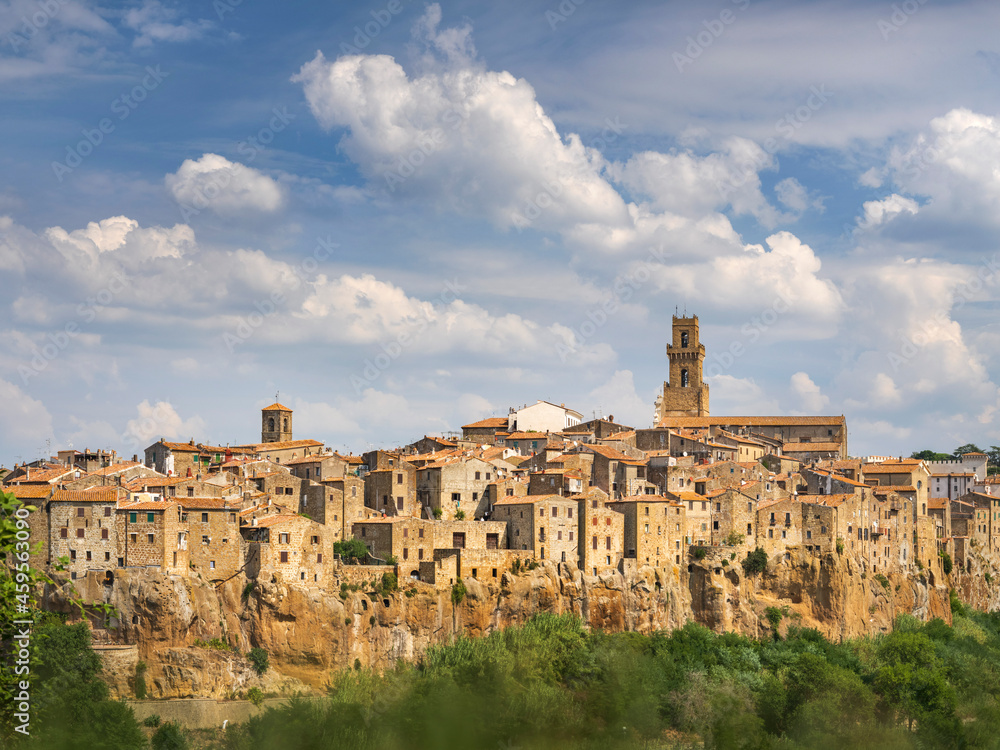 calendar view to tuscany city Pitigliano in Italy in summer day with light clouds