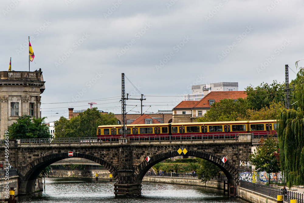 View of a traditional S-Bahn City Train crossing the Spree River in the City Center of Berlin, Germany