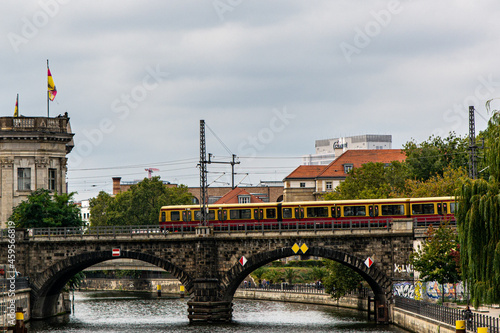 View of a traditional S-Bahn City Train crossing the Spree River in the City Center of Berlin, Germany