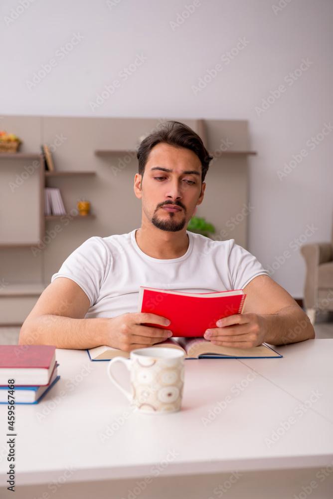 Young male student studying at home during pandemic Young male student studying at home during pandemic