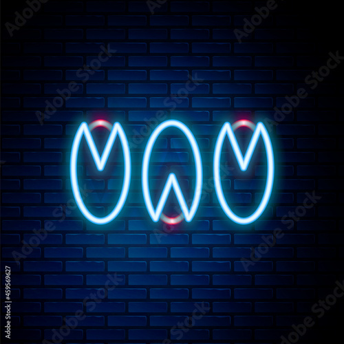 Glowing neon line Pistachio nuts icon isolated on brick wall background. Colorful outline concept. Vector