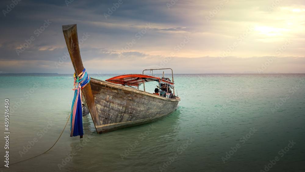 Longtail boat on a beach in thailand at sunset