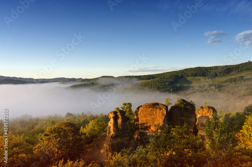 The rock towers of the Dragons Garden (Gradina Zmeilor ), a protected geological nature reserve in Salaj, Transylvania region, Romania, at sunrise, in summer foggy morning