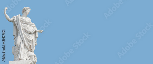 Old roof statue of a beautiful Renaissance Era woman philosopher and poet with her hand up as she declares something in Potsdam at white blue sky background and copy space, Germany.