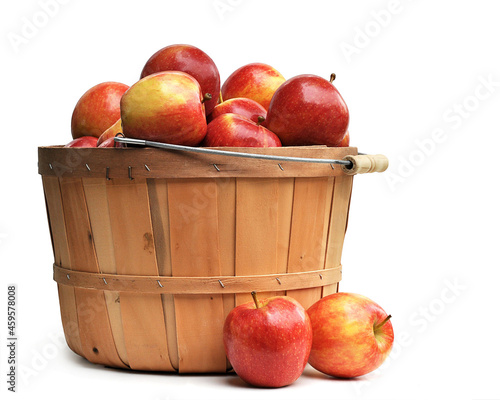 Apples in a Wooden Basket on white photo