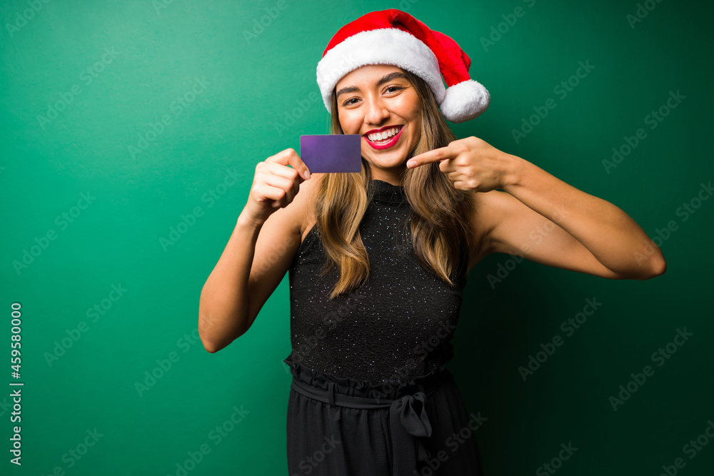 Smiling woman holding a credit card Smiling woman holding a credit card
