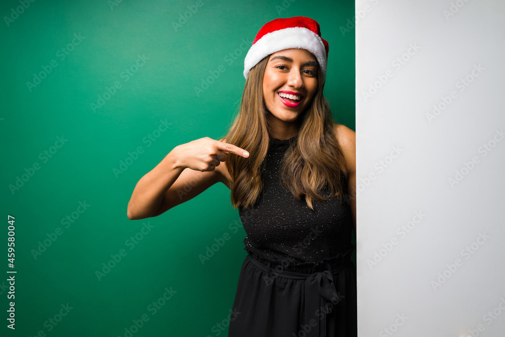 Cheerful woman pointing to copyspace Cheerful woman pointing to copyspace
