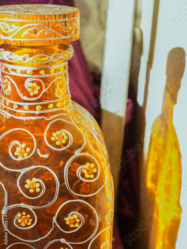 Decorated glass bottle with floral motifs photo