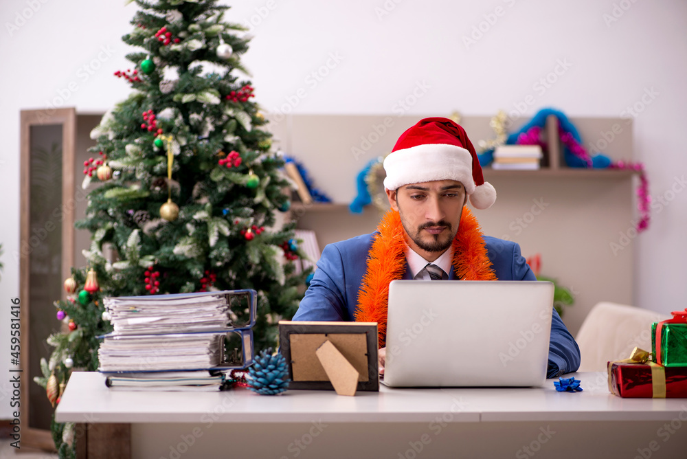 Young businessman working from home at Christmas eve