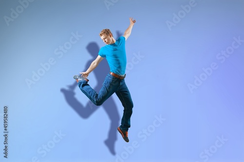 Full length body of attractive funny cheerful guy jumping having fun
