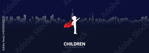 Silhouette of boy in superhero suit point to sky in city. Concept of education start and future of children.