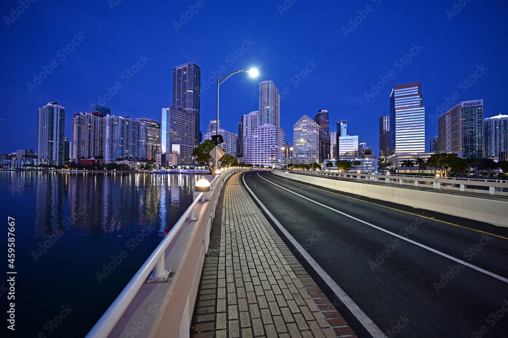 Brickell Key Bridge and City of Miami skyline in pre dawn twilight on calm clear summer morning. Brickell Key Bridge and City of Miami skyline in pre dawn twilight on calm clear summer morning.