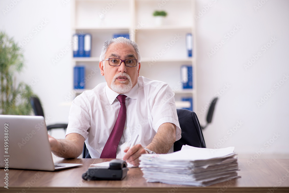 Old male employee and too much work in the office Old male employee and too much work in the office
