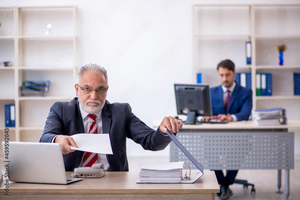 Two male colleagues working in the office Two male colleagues working in the office