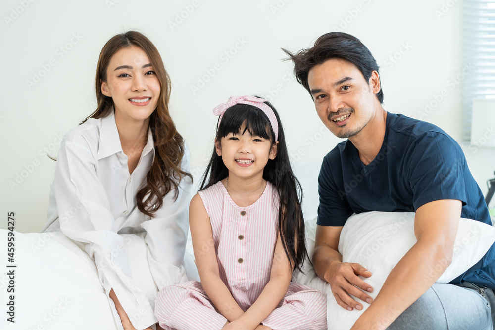 Portrait of Asian happy family smile and look at camera on bed at home. Portrait of Asian happy family smile and look at camera on bed at home.