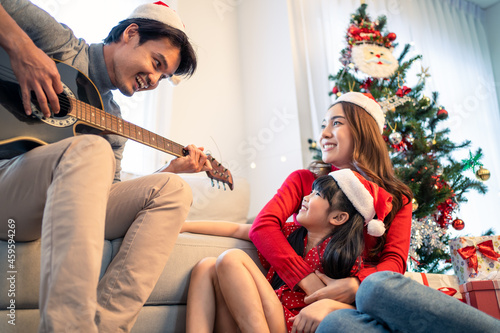 Asian lovely family member enjoy sing Christmas song together at home. 